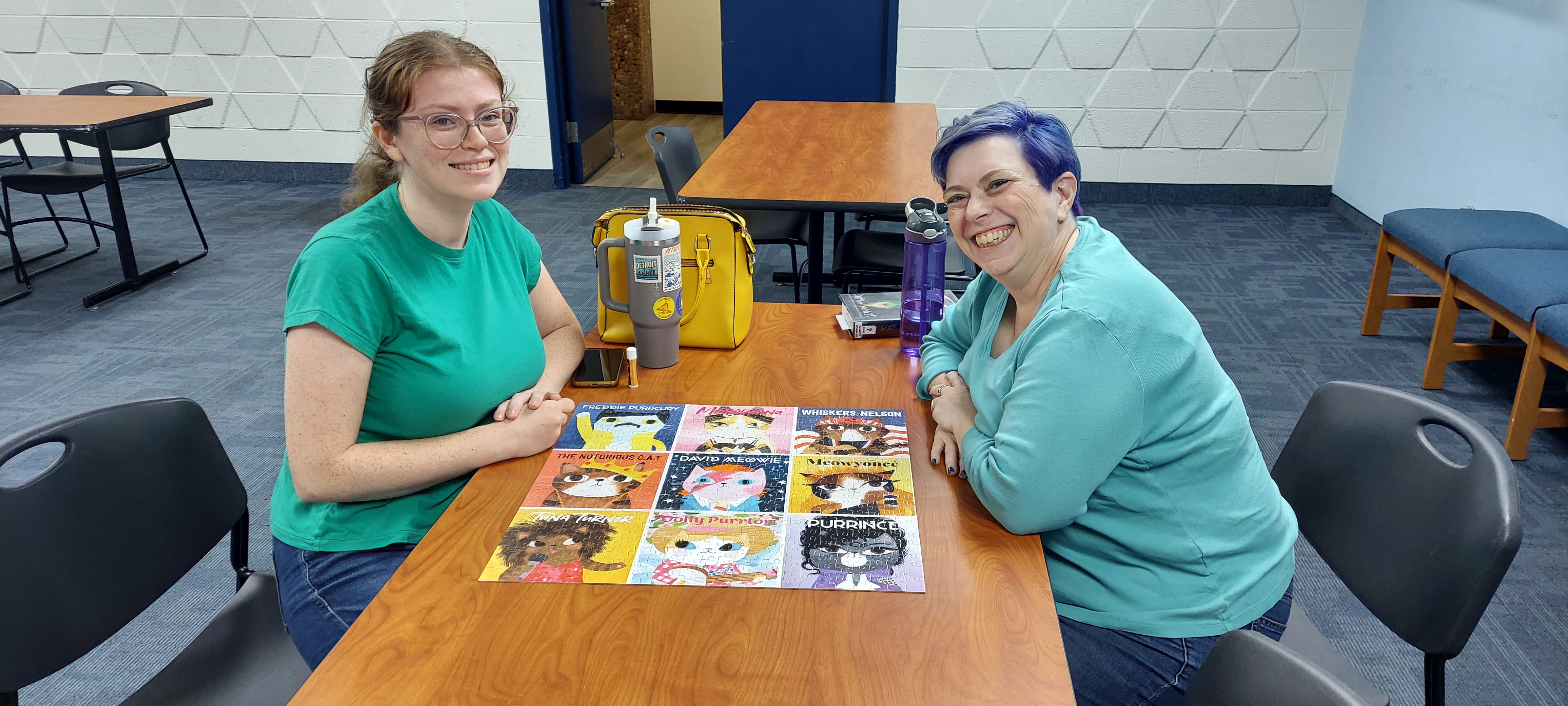 Picture of the participants of the first team in the August 2026 Adult Jigsaw Puzzle Competition displaying their made puzzle.