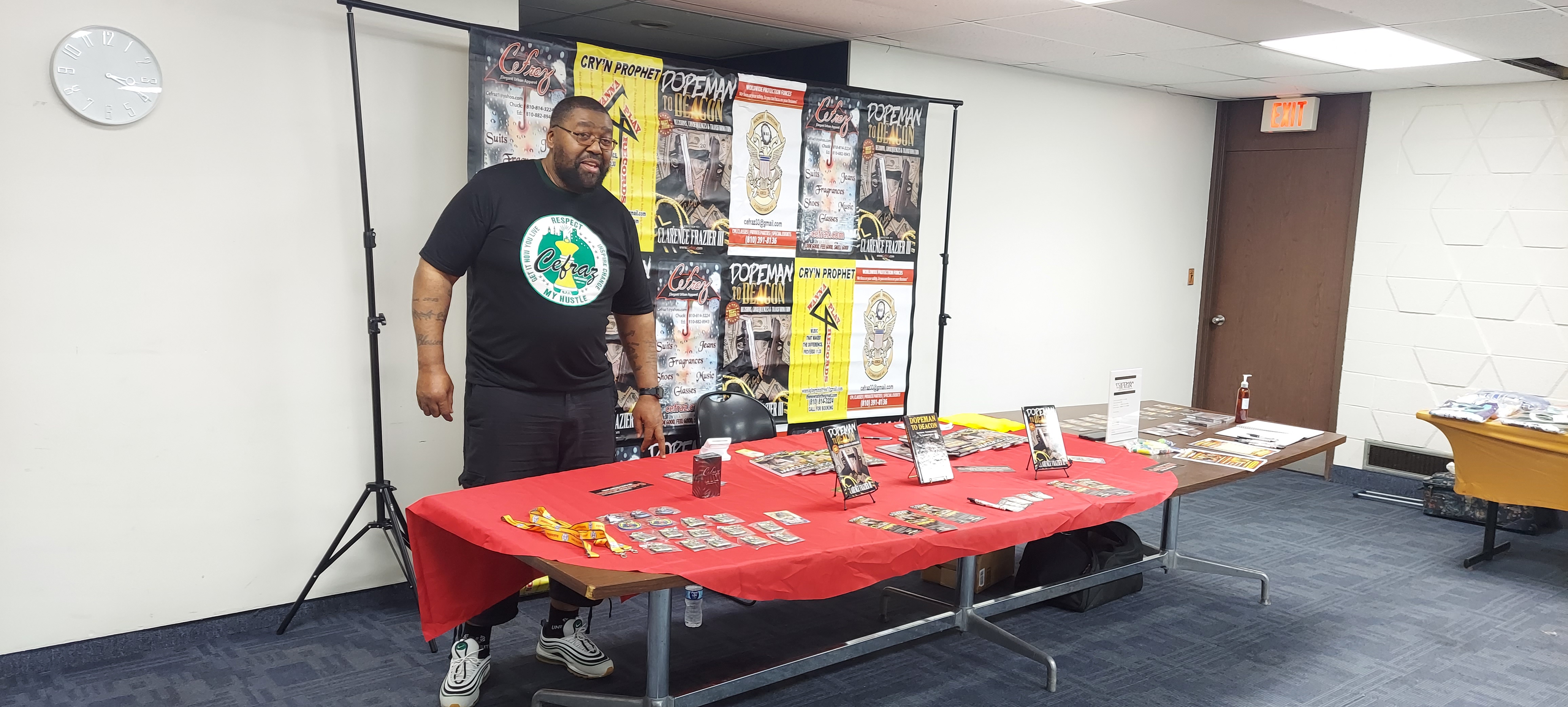 Author Clarence Frazier III presents his book "Dopeman to Deacon" in the library's Auditorium, standing by his display in front of participants, on September 20th 2026.